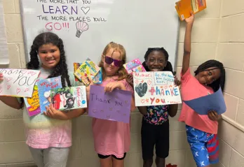 4 kids holding books