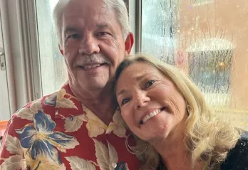 Sherry, a member of the engagement staff at the Bear Levin Studer Y, is pictured smiling while standing with her husband.