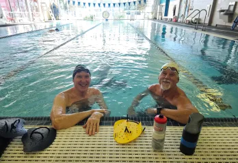 Two members are pictured in a lane at the lap pool indoors at the Bear Levin Studer YMCA.