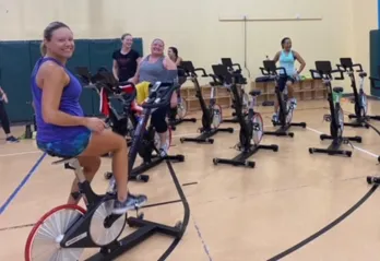 A group begins to arrive and get set for a cycling class at the Betty J. Pullum YMCA.