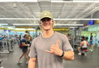 Featured member John smiles for a photo taken on the fitness floor at the Bear Levin Studer YMCA.