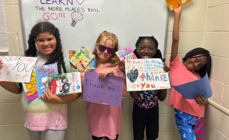 4 kids holding books