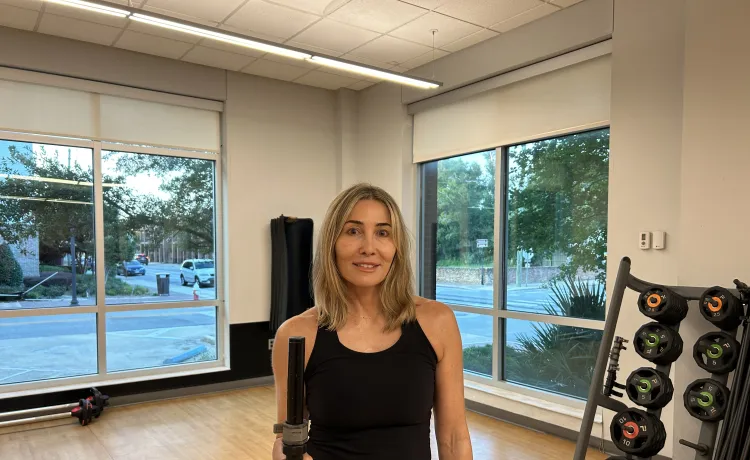 The featured member, Kristen, is pictured in a studio at the Bear Levin Studer Y before working out.