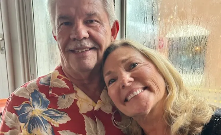 Sherry, a member of the engagement staff at the Bear Levin Studer Y, is pictured smiling while standing with her husband.