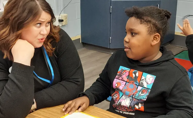 Y Reads Site Coordinator Symphani is pictured working one on one with a student in the program after school at Ferry Pass Elementary.