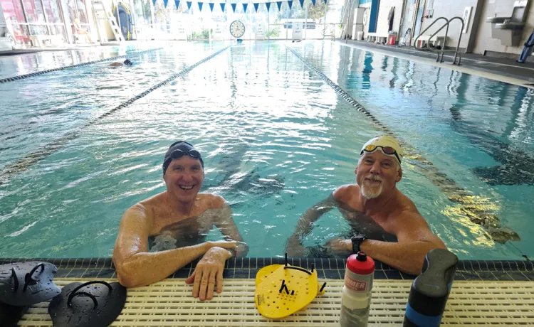 Two members are pictured in a lane at the lap pool indoors at the Bear Levin Studer YMCA.