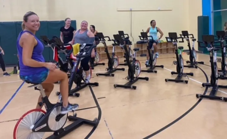 A group begins to arrive and get set for a cycling class at the Betty J. Pullum YMCA.