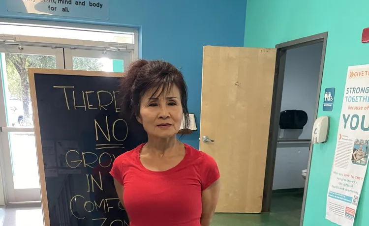 Group fitness instructor Hyon poses for a photo near the entryway of the Betty J. Pullum YMCA.