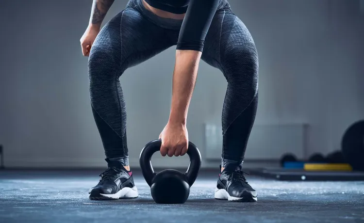 A photo shows a woman working out with a kettlebell.