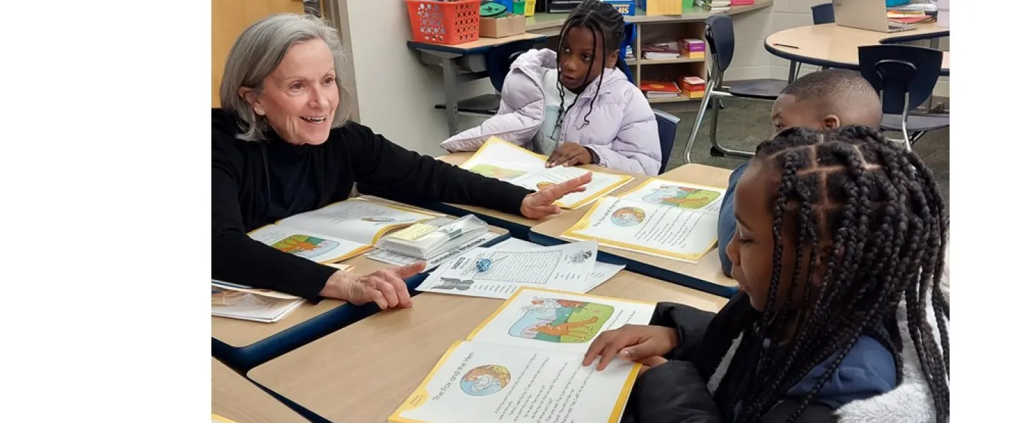 woman reads with students