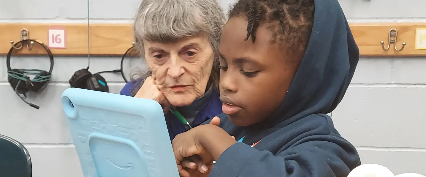 woman reads with a student