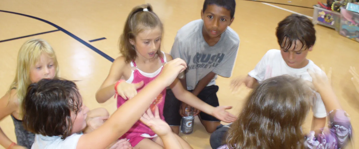 kids sit in a circle for a game