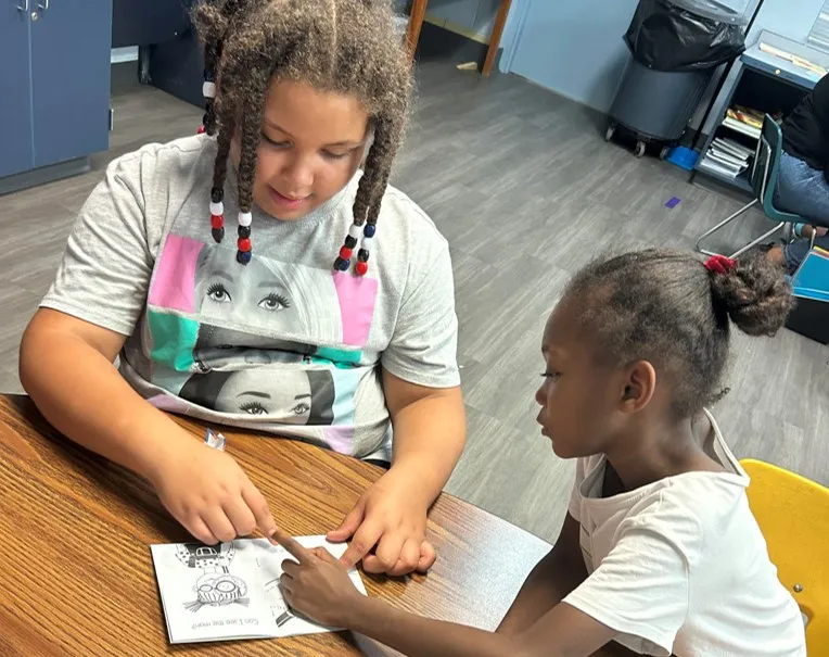 two girls reading together