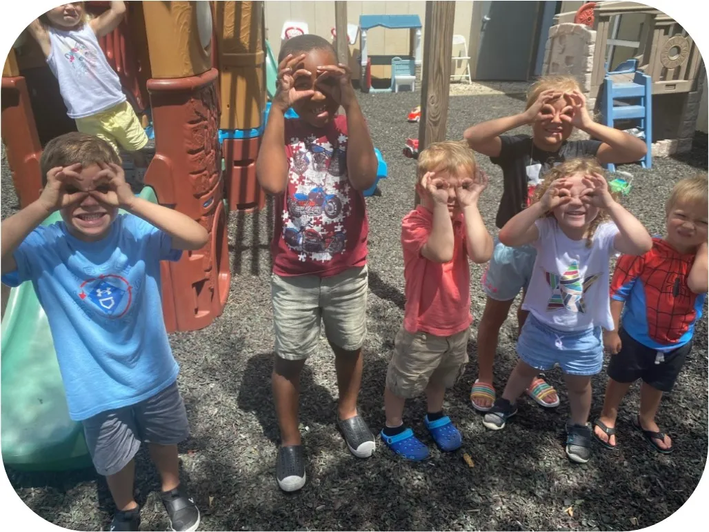 children making binoculars with their fingers