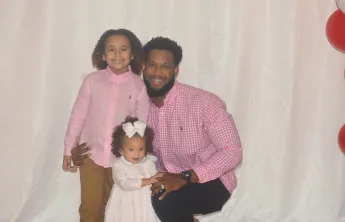 Dad with daughters at a dance